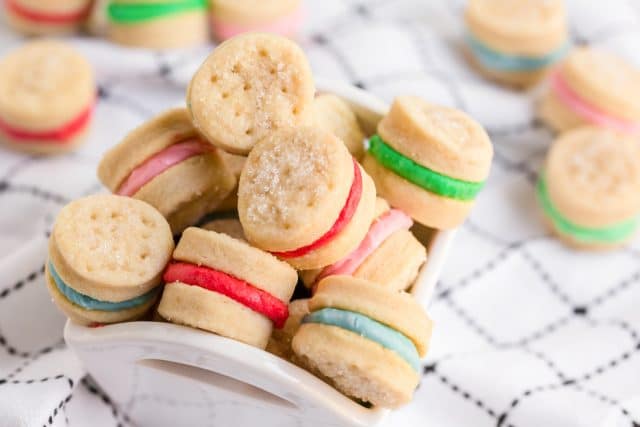 bowl of sugar wafer cookies with colorful frosting