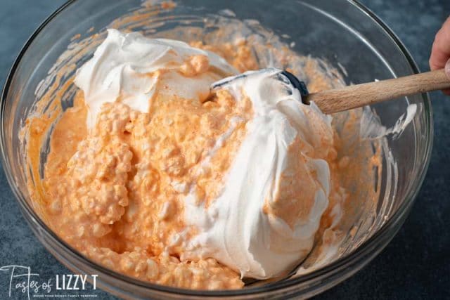 mixing orange fluff salad