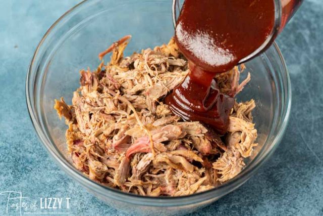 barbecue sauce pouring over pulled pork