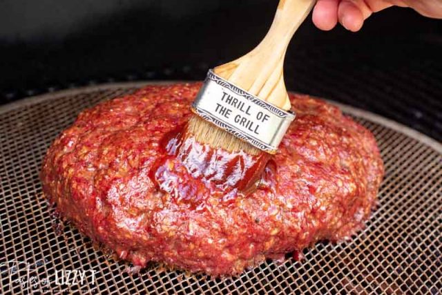 basting barbecue sauce on meatloaf
