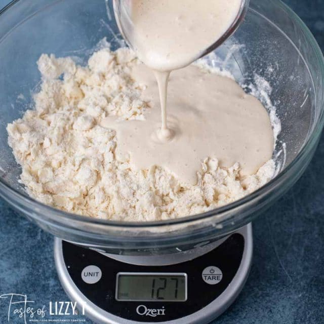 pouring sourdough on flour
