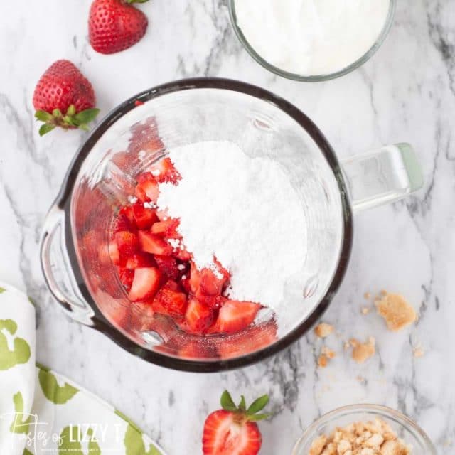 strawberries and powdered sugar in a blender