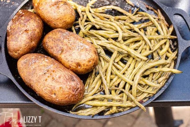 potatoes and green beans on a cast iron skillet