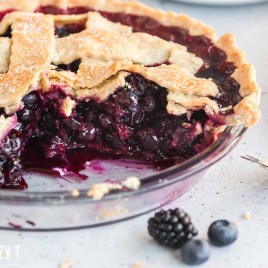 Blueberry Blackberry Pie in a pan with two pieces missing