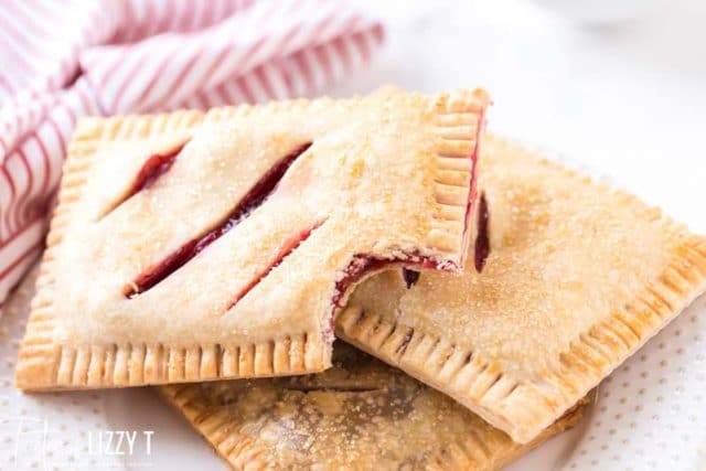 3 cherry hand pies one with a bite out
