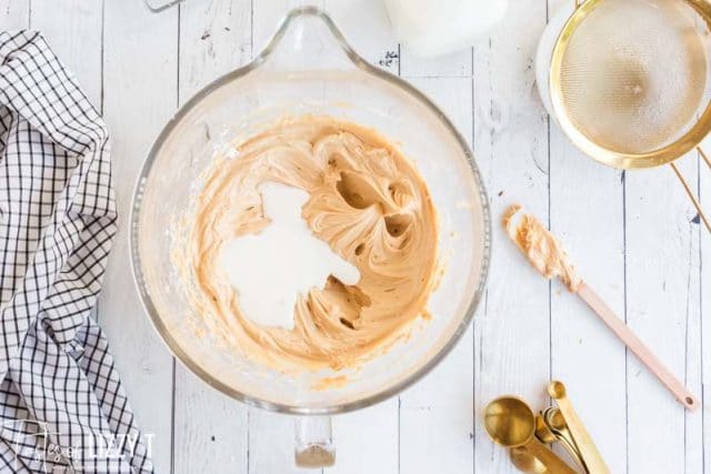 mixing peanut butter frosting in a mixing bowl
