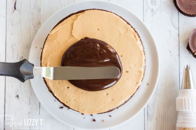 spreading ganache on a cake