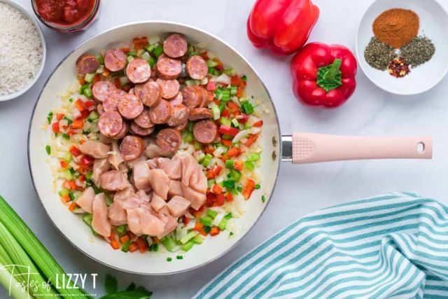 chicken and sausage in skillet for jambalaya