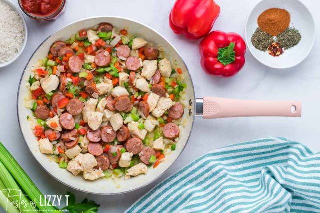 chicken and sausage in skillet for jambalaya