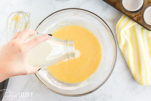 pouring milk into cupcake batter