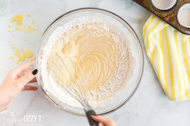 mixing flour into cupcake batter