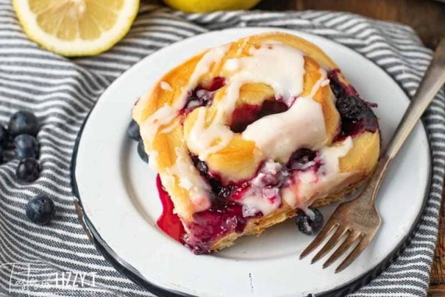 Lemon Blueberry Sweet Roll on a plate with a fork