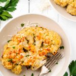 cauliflower steak on a plate with parmesan