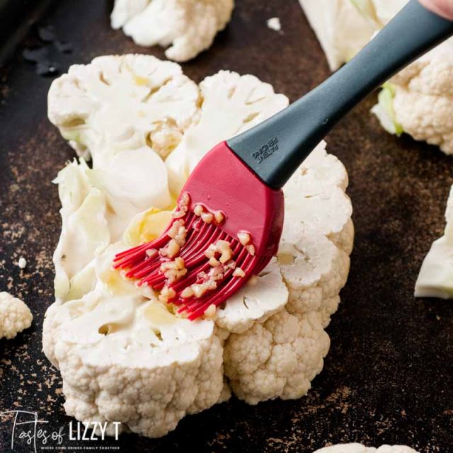 brushing olive oil over a cauliflower steak