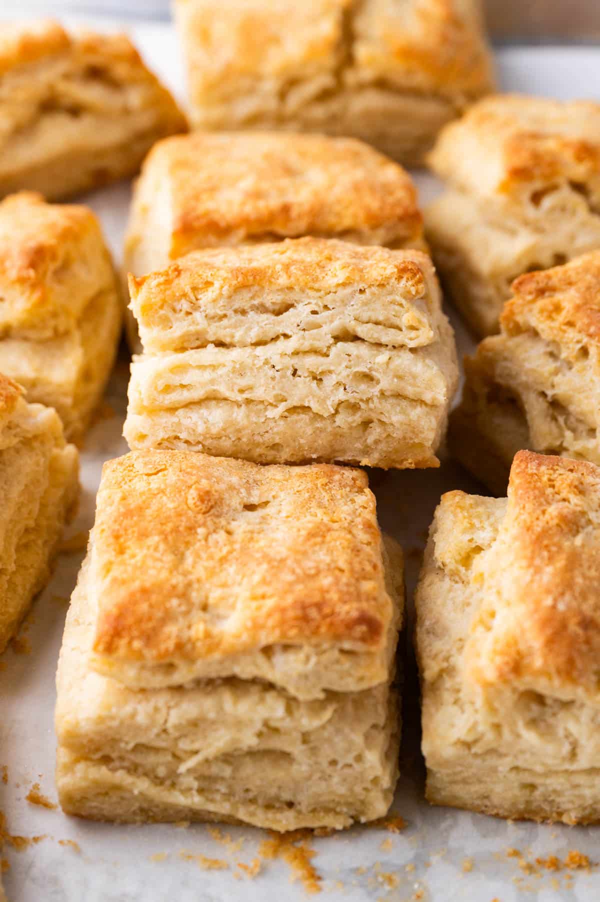flaky sourdough discard biscuits sitting on a pan