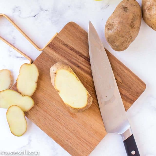 sliced potatoes on cutting board
