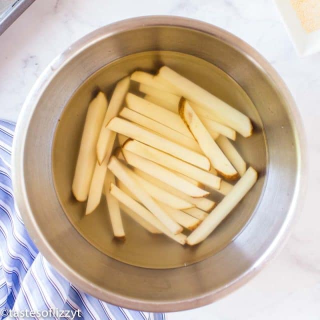 cut potatoes in a bowl of water