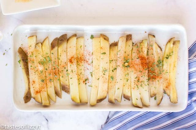 cut potatoes on a plate with seasonings