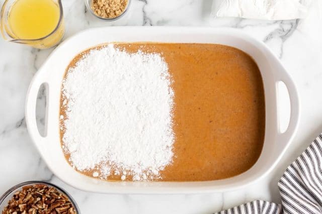 cake mix over pumpkin in a baking pan