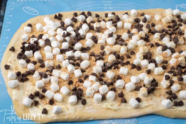 dough rolled out with marshmallows and chocolate