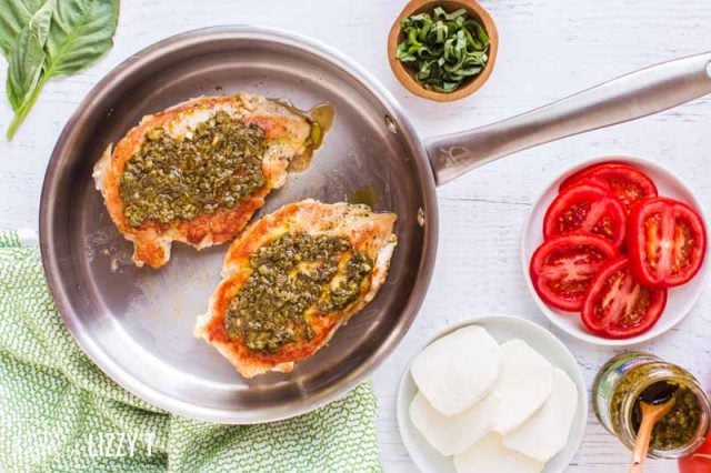 chicken in a skillet with pesto