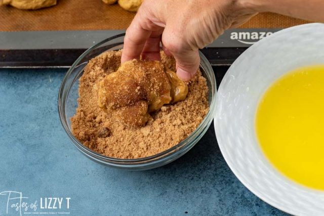 dipping rolls in butter and brown sugar