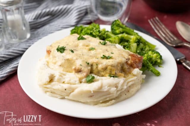 pork chop on potatoes with broccoli