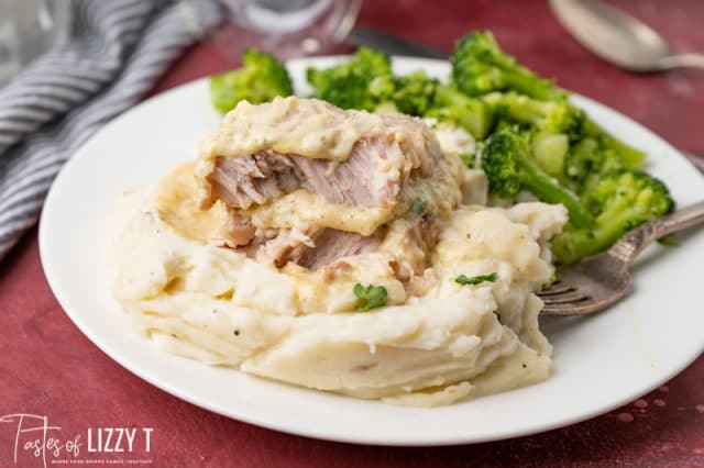 cut open pork chop over potatoes