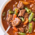 vegetable soup in a bowl with a spoon