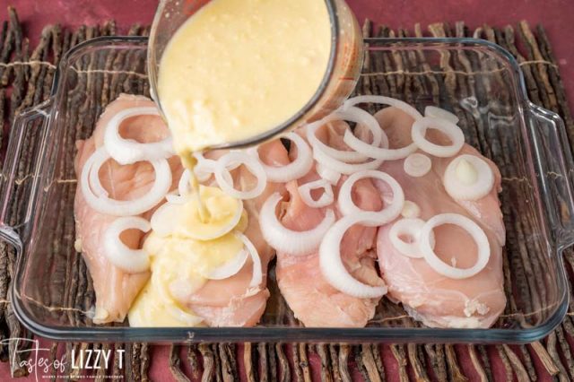 pouring gravy over chicken and onions