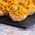 pumpkin cheesecake tarts sitting on slate board