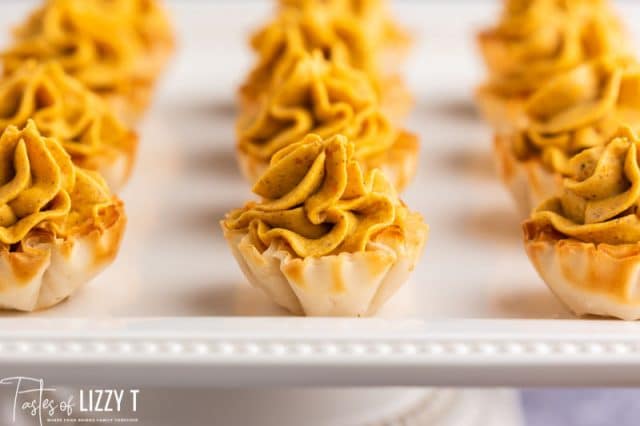 pumpkin mini pies on a cake plate