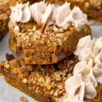 two slices of pumpkin cookie pie one with a bite out