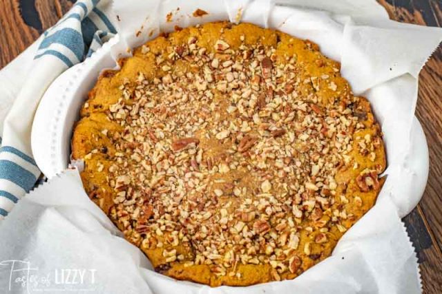 pumpkin cookie pie in a baking pan with parchment