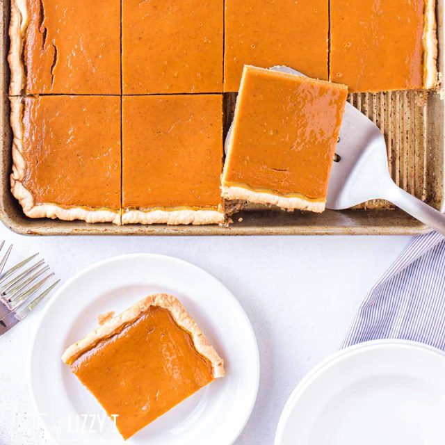 overhead view of pumpkin slab pie with one piece on plate