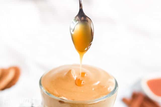 caramel drizzling off spoon