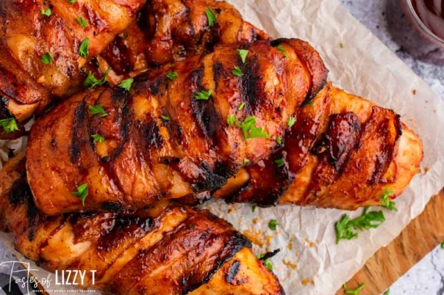 pile of bacon wrapped bbq chicken on cutting board