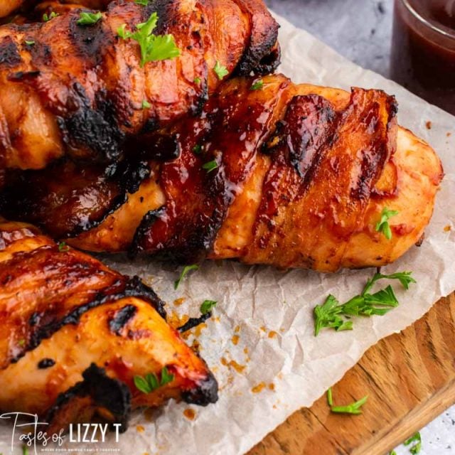 pile of bacon wrapped bbq chicken on cutting board