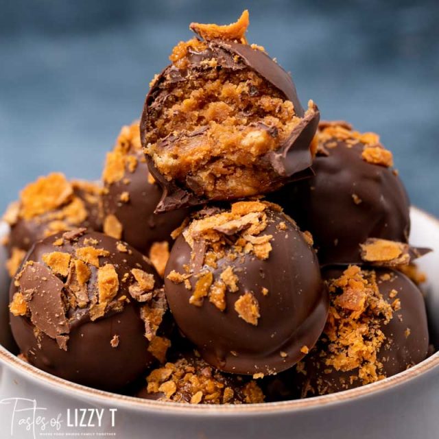 pile of butterfinger truffles, one with a bite out