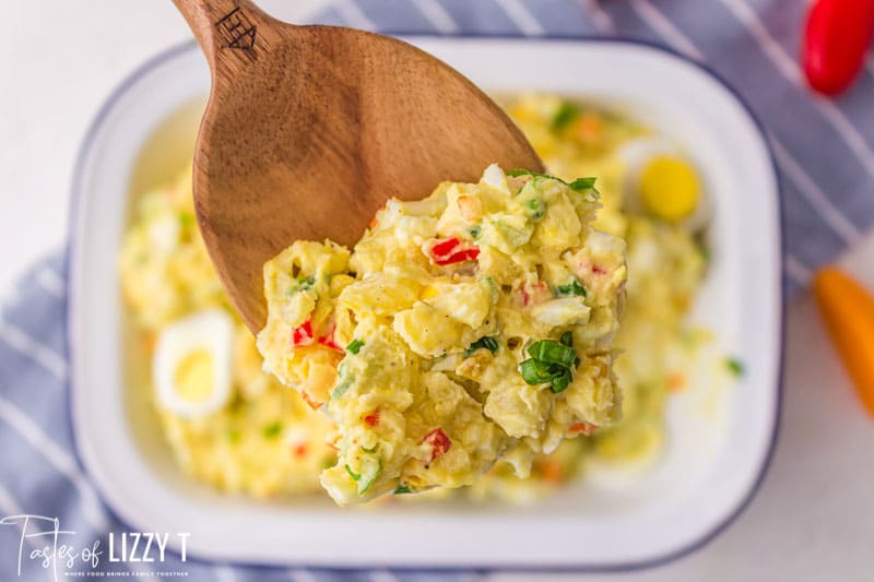 cajun potato salad on a wooden spoon