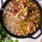 pot of chicken sausage gumbo on a ladle