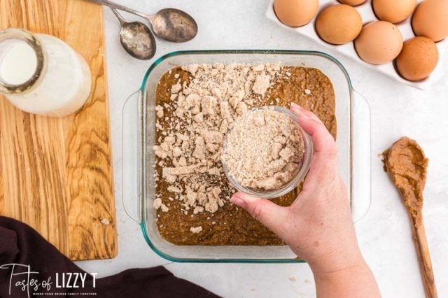 sprinkling streusel over an unbaked cake