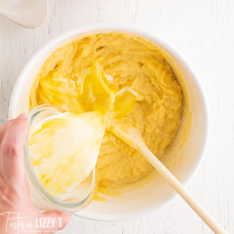 pouring butter into potatoes