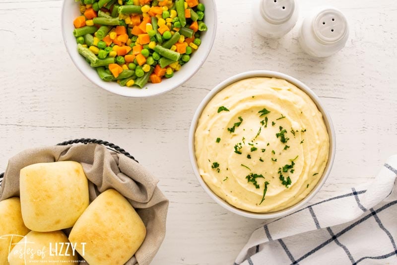 table with instant potatoes, rolls and mixed vegetables