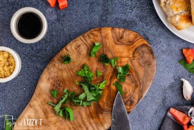 freshly snipped basil on a cutting board