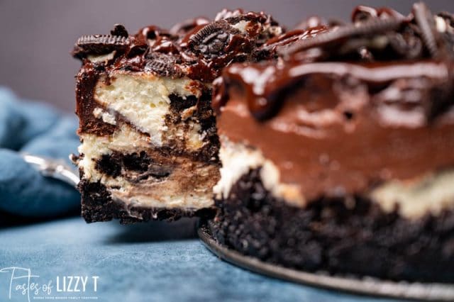 slice of oreo cheesecake on spatula pulling out of cake