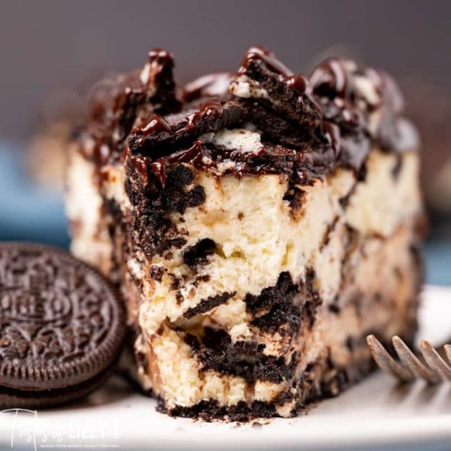 slice of oreo cheesecake on a plate with a bite out