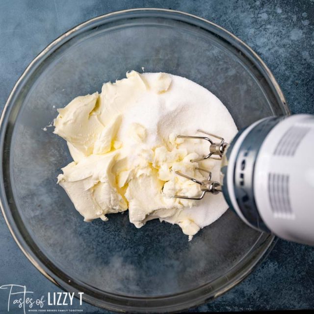 cream cheese and sugar in a mixing bowl