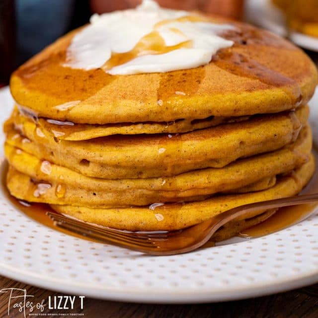 stack of pumpkin pancakes with syrup and butter