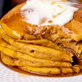 stack of pancakes with a fork cutting in